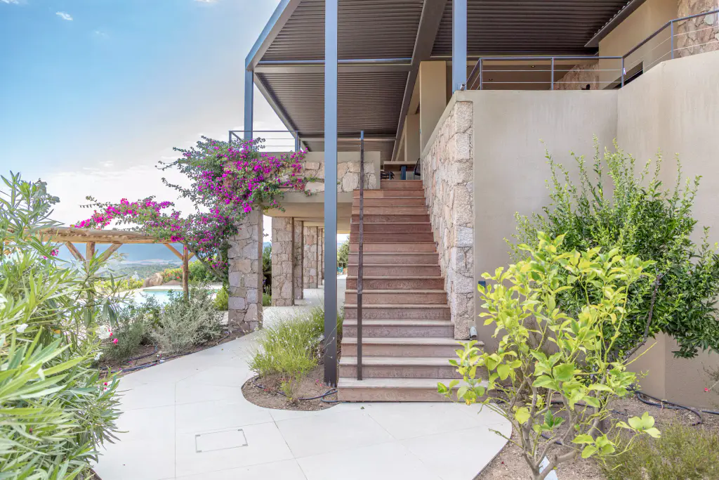Stone staircase, bougainvillea and anthracite pergola above.